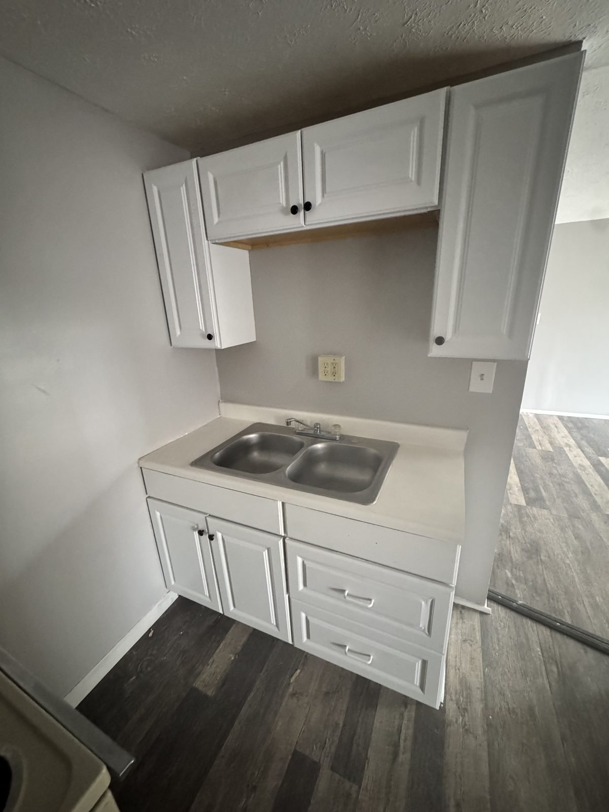 Kitchen after: new cabinets, sink and flooring