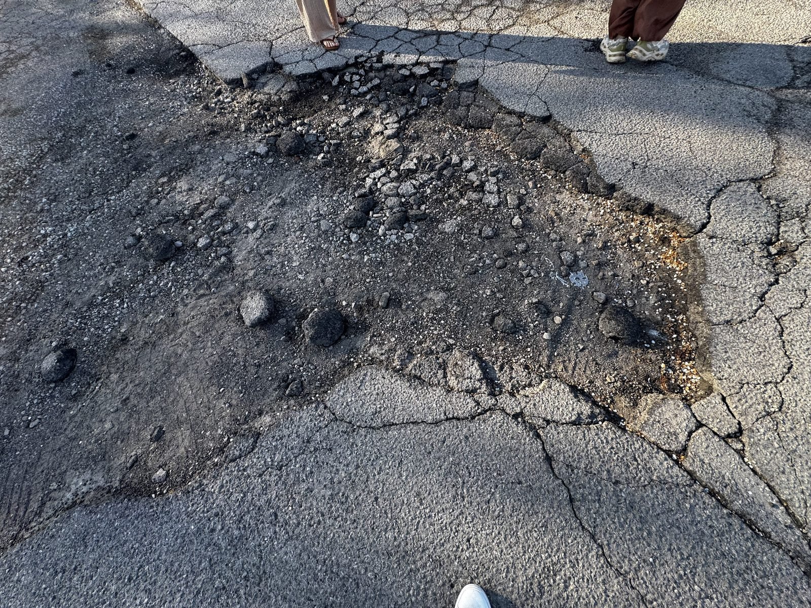 Parking lot before: broken asphalt and rubble